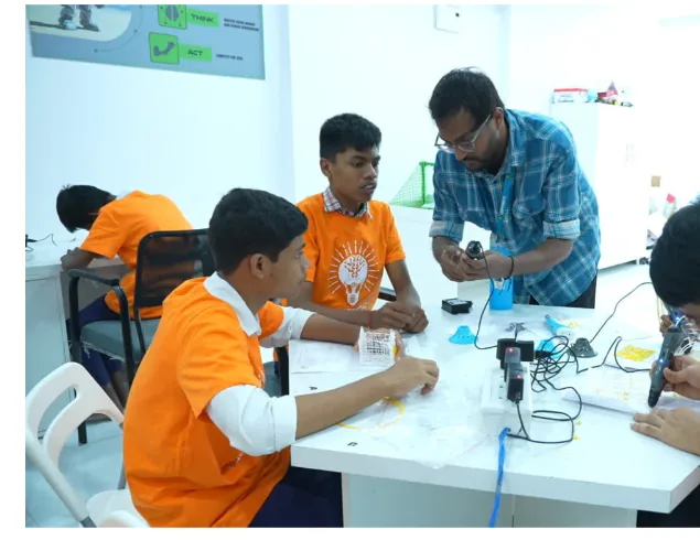 Students receiving guidance during a 3D pen activity